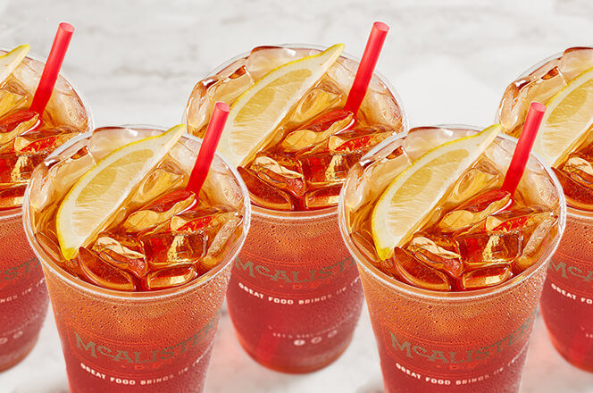 Five cups of McAlister’s Tea, served with lemon wedges, showcasing the signature beverage.