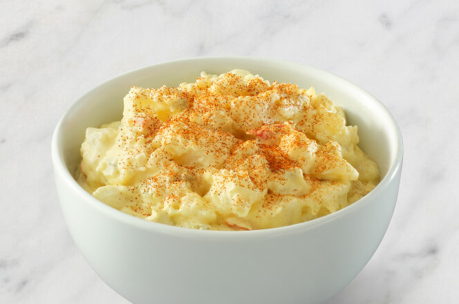A serving of potato salad with creamy dressing.