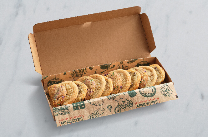 A cookie box themed for Mardi Gras with festive colored icing.