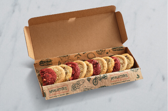 A box of assorted red velvet, chocolate chip and sugar cookies.