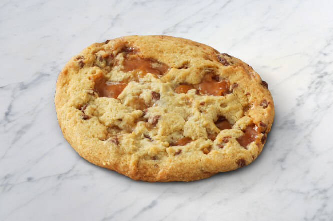 A salted caramel cookie with a drizzle of caramel and a touch of sea salt.
