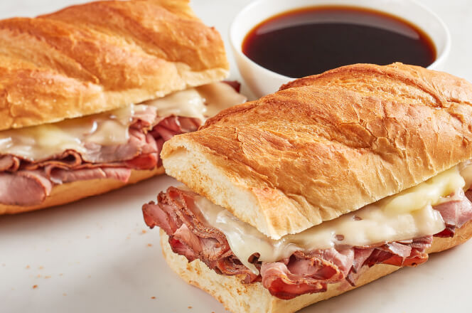 A 12-inch French Dip sub featuring roast beef, Swiss cheese, and a side of au jus.