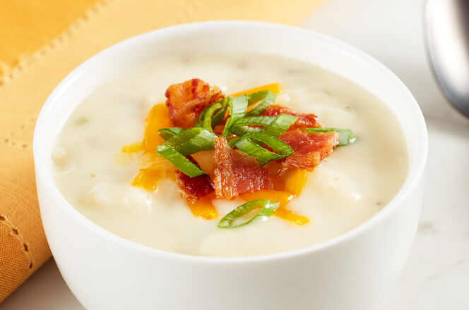 A bowl of country potato soup with bacon, potatoes, and creamy broth.