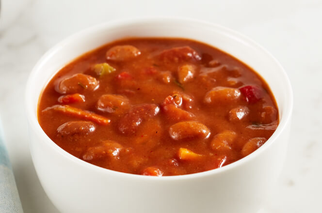 A bowl of vegetarian chili with beans, tomatoes, and a medley of vegetables.